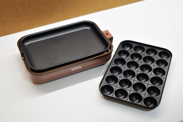Electric takoyaki grill with a brown base and a removable 25-well nonstick pan.