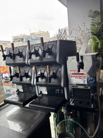 IMG_1086 Commercial multi-tap beer/draft dispenser with several taps and brown handles, mounted on a counter by a window.
